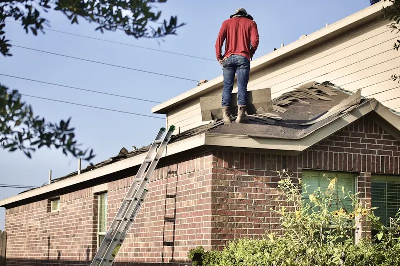 Professional roofer working on a residential roof in Stanfield